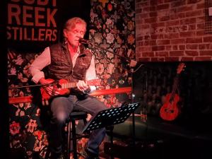 man playing ukulele