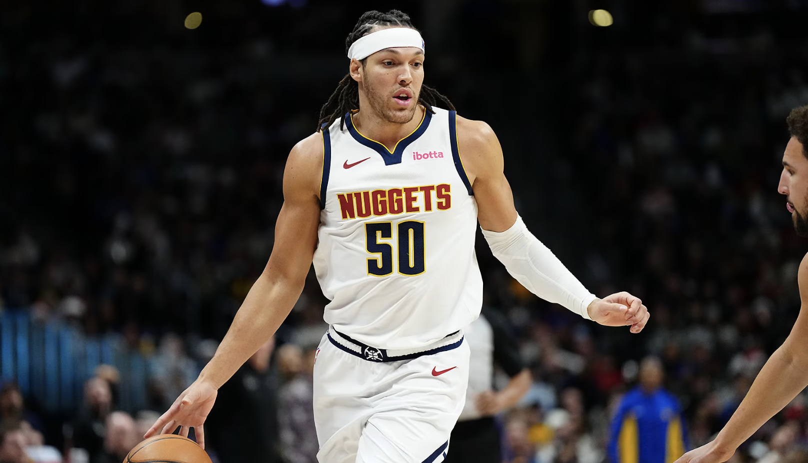 Denver Nuggets player Aaron Gordon dribbling a basketball.