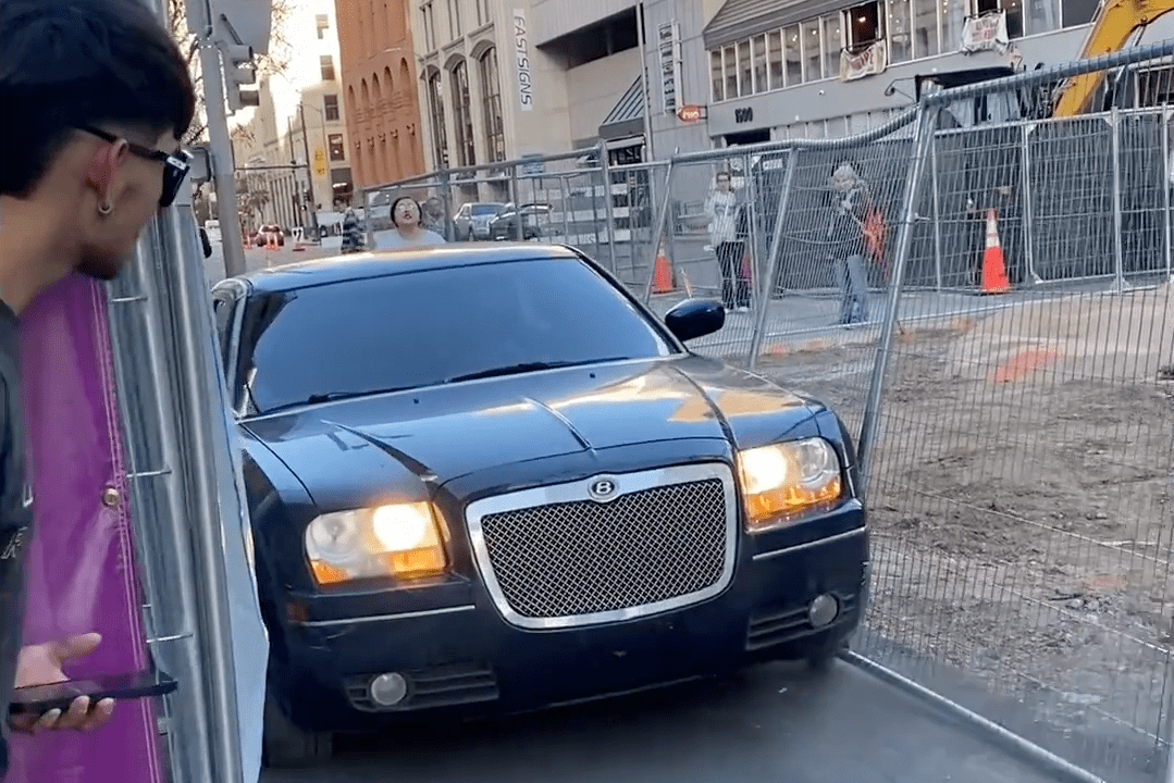 Black Chrysler 300 with fake Bently sign drives through fence