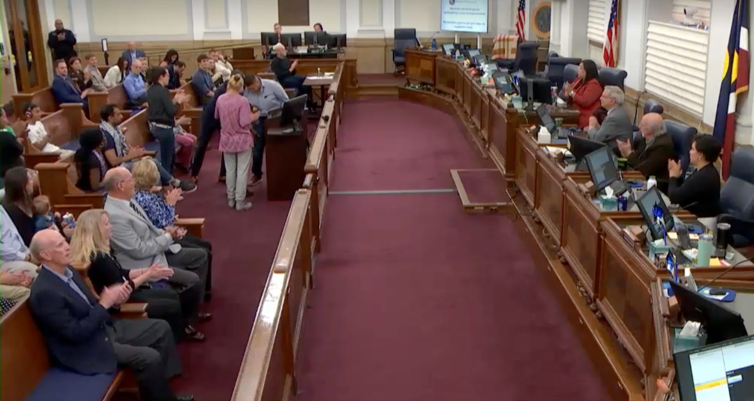 Crowds surround Denver City Council during a meeting