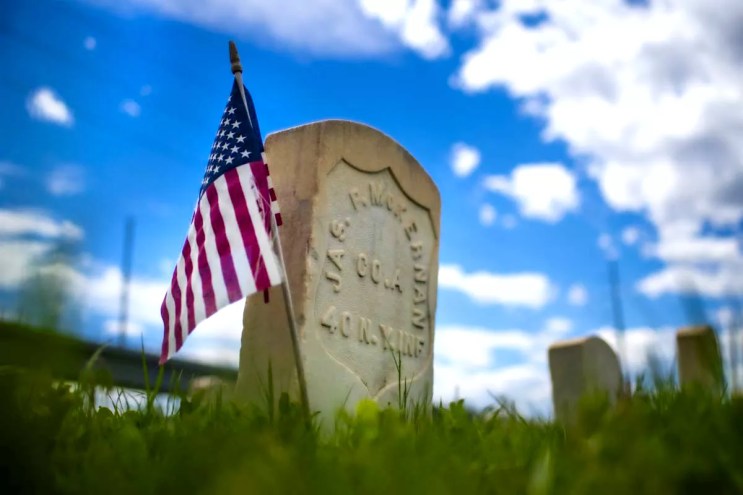 gravestone with flags.
