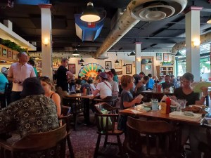 people sitting at tables inside a restaurant