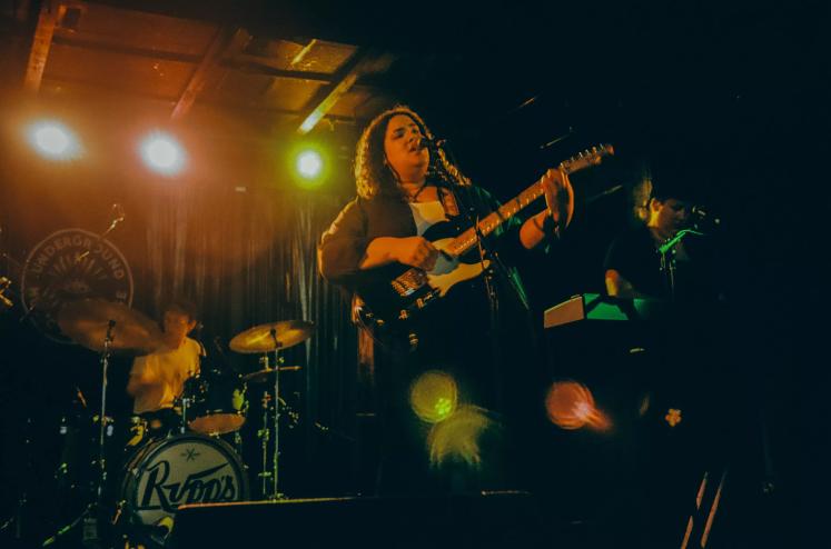 woman singing on stage