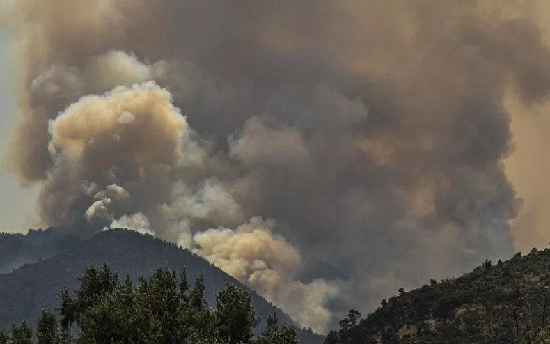 fire and smoke behind mountain