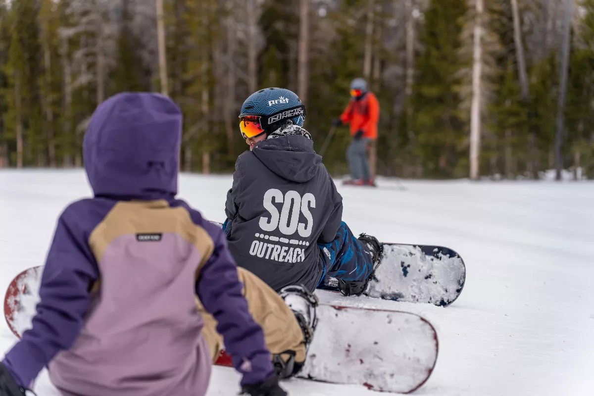A boy snowboards.