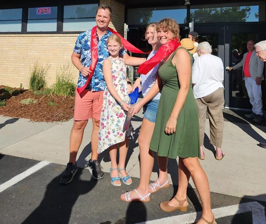 family in front of community space