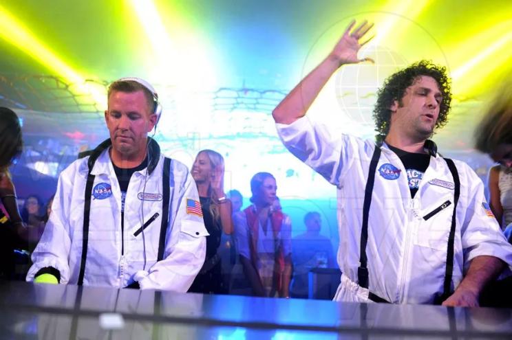 two djs performing