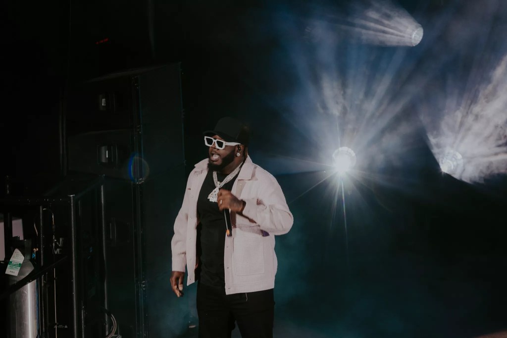 A photo of T-Pain on stage performing at Red Rocks in Morrison, Colorado.