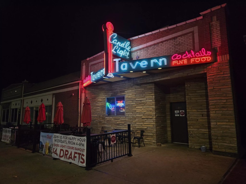 bar exterior with a neon sign