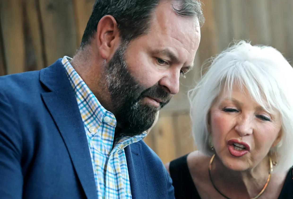 man with beard in jacket with blonde woman