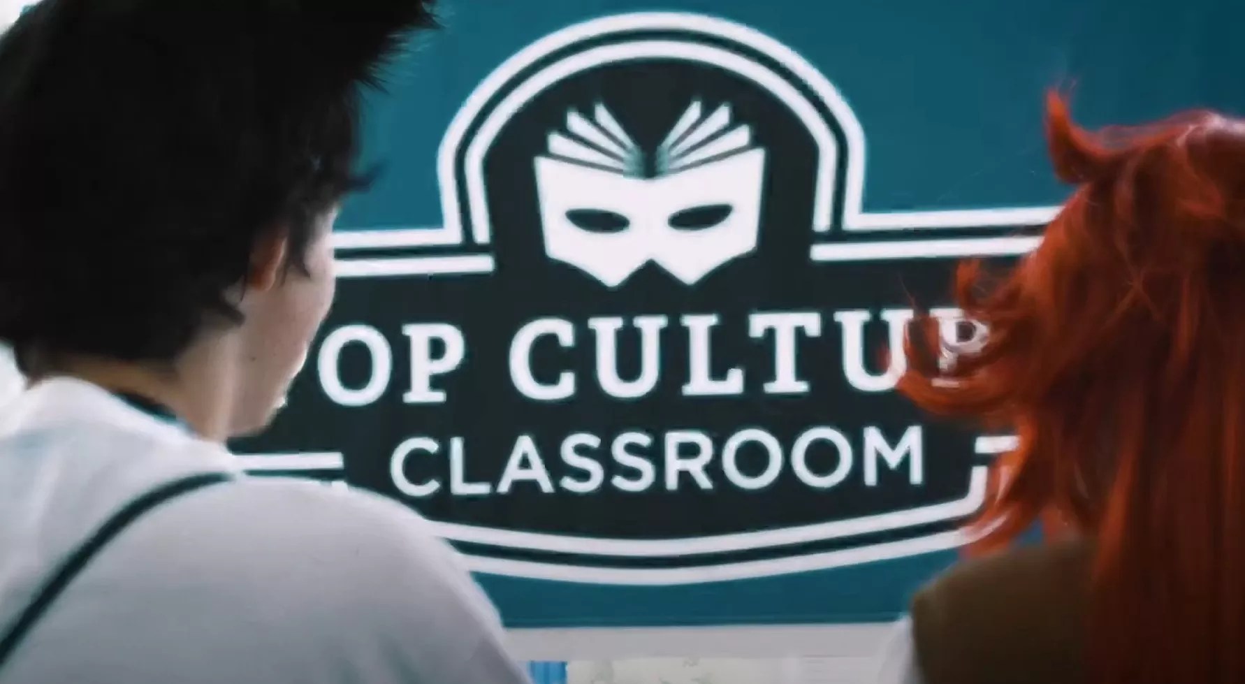 pop culture classroom sign with back of people's heads.