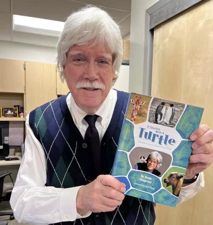 Man holds a book.