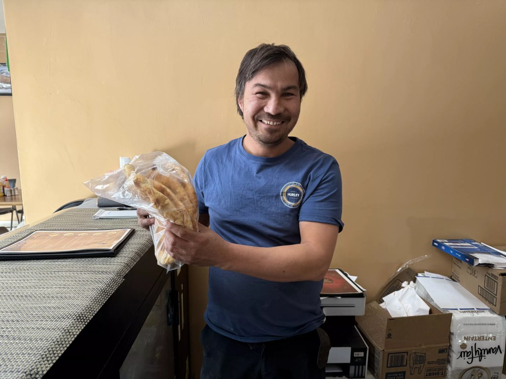 man holding bag of flatbread