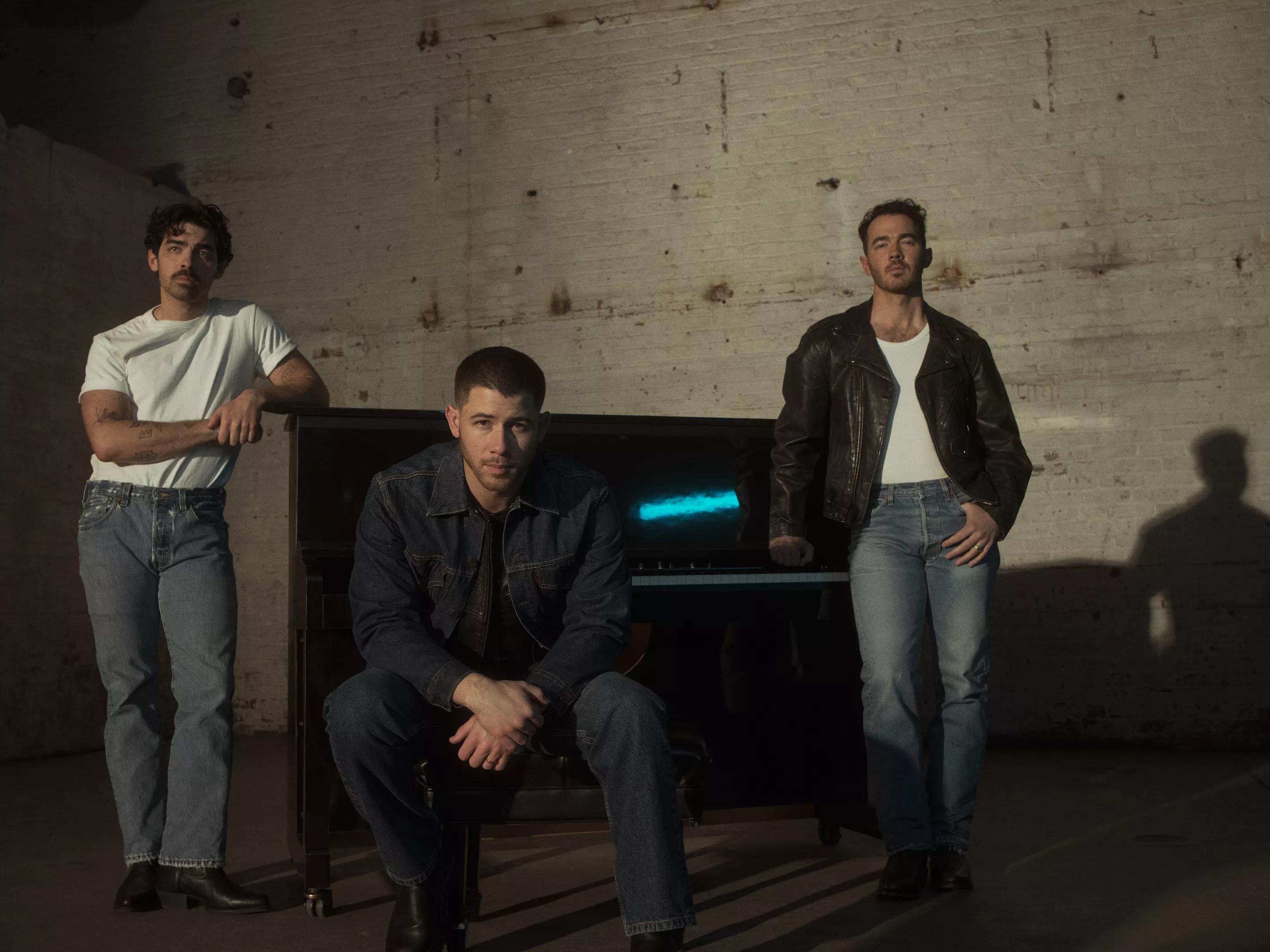 members of the Jonas Brothers looking moody