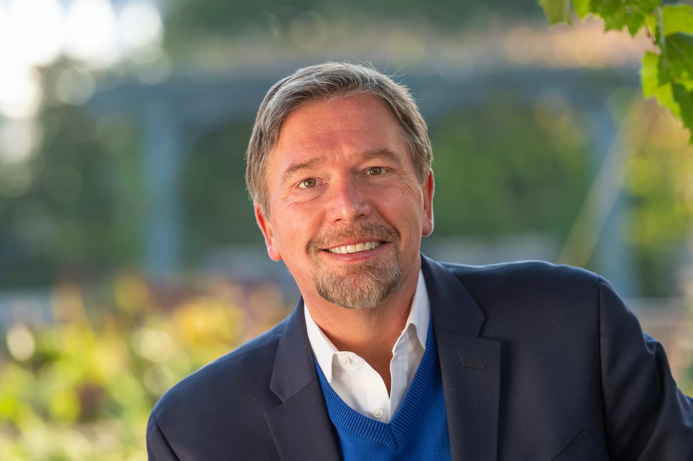 man with beard in blue jacket, white shirt