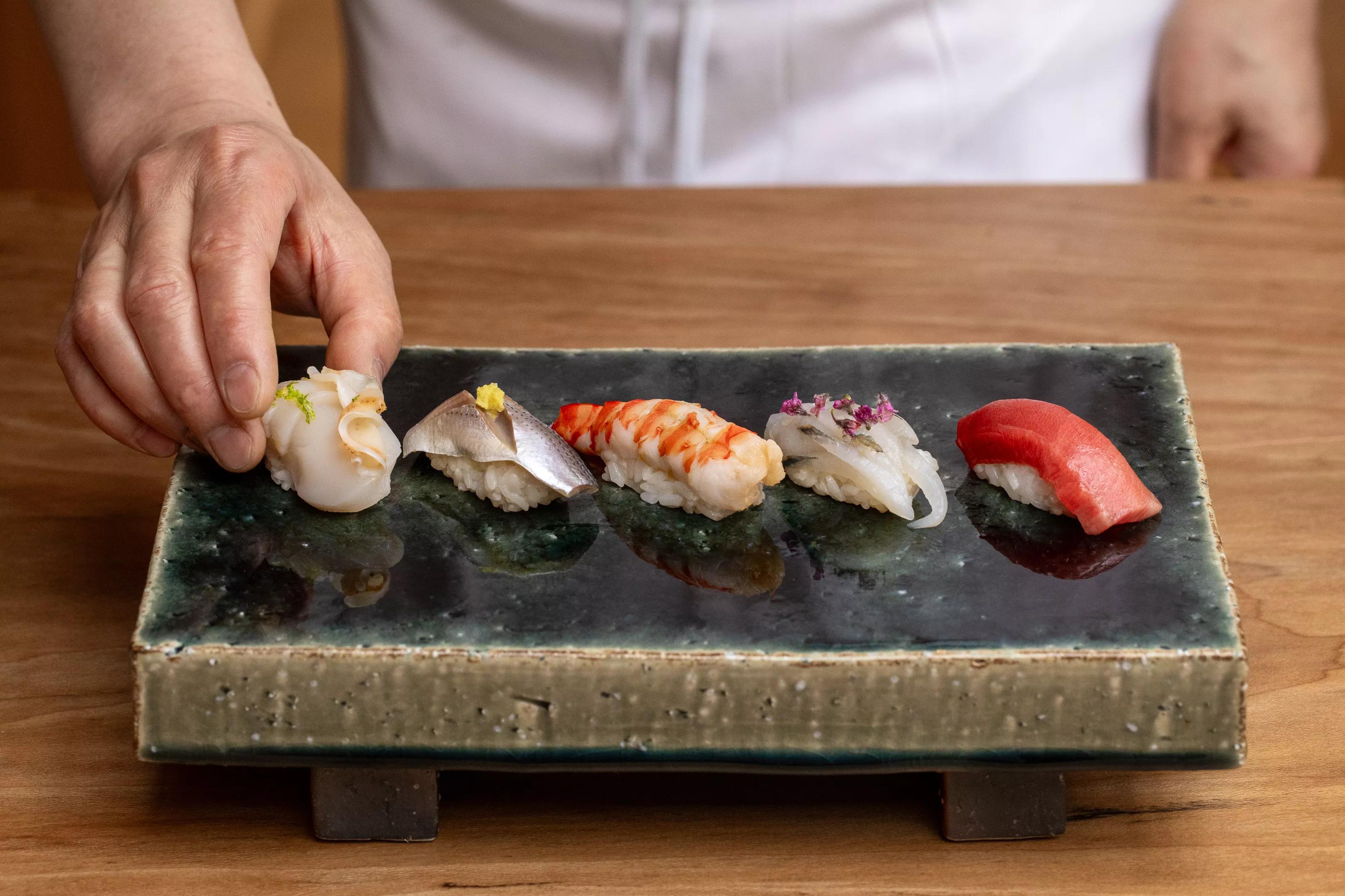 sushi on a black plate