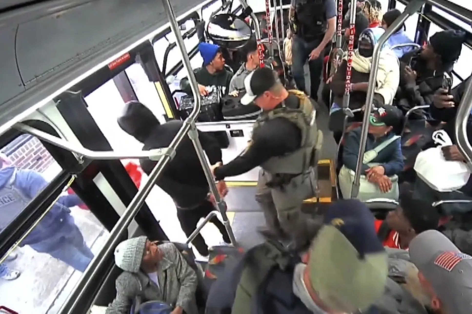 A man is arrested on a bus.