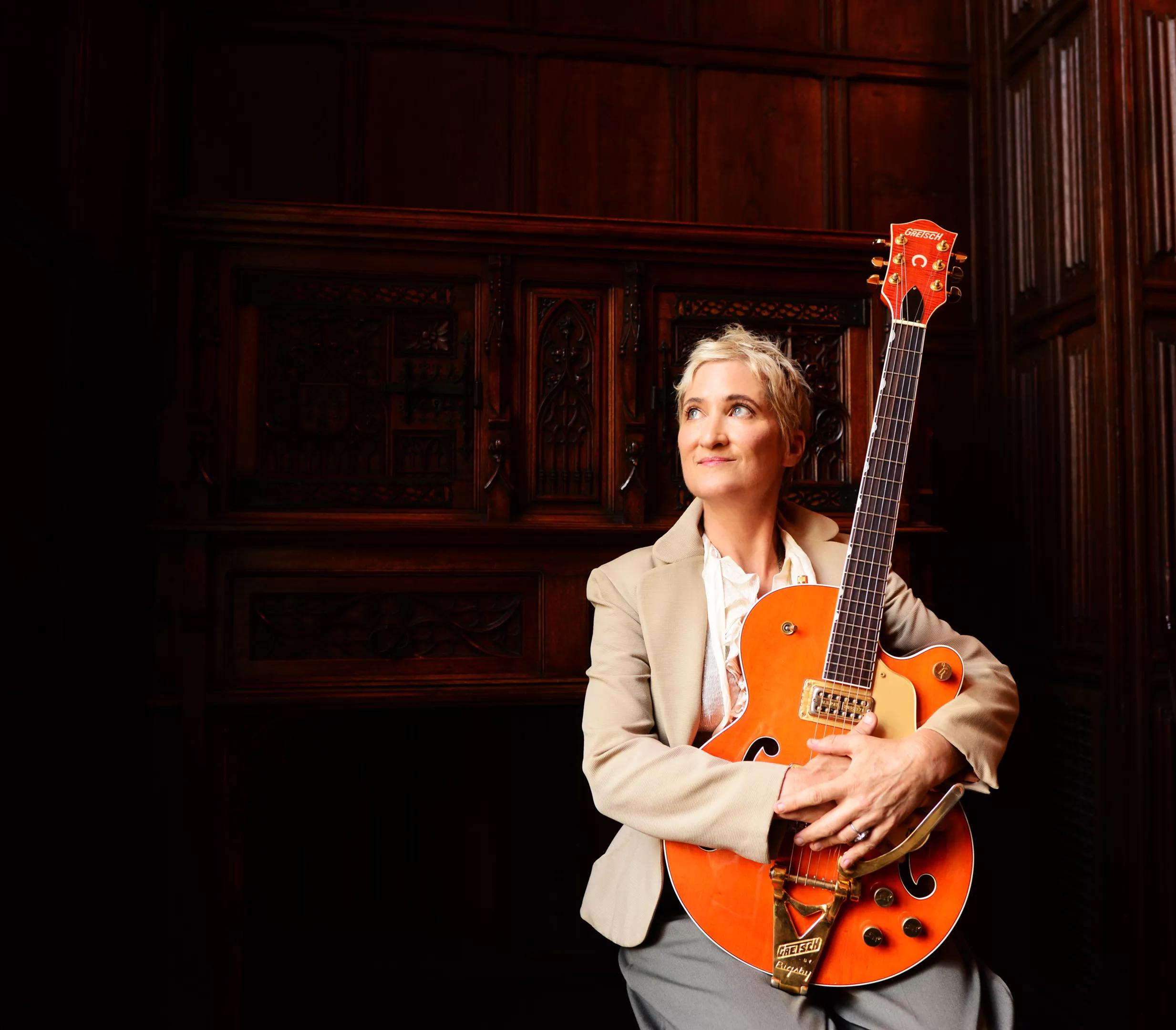 denver musician jill sobule holding a guitar