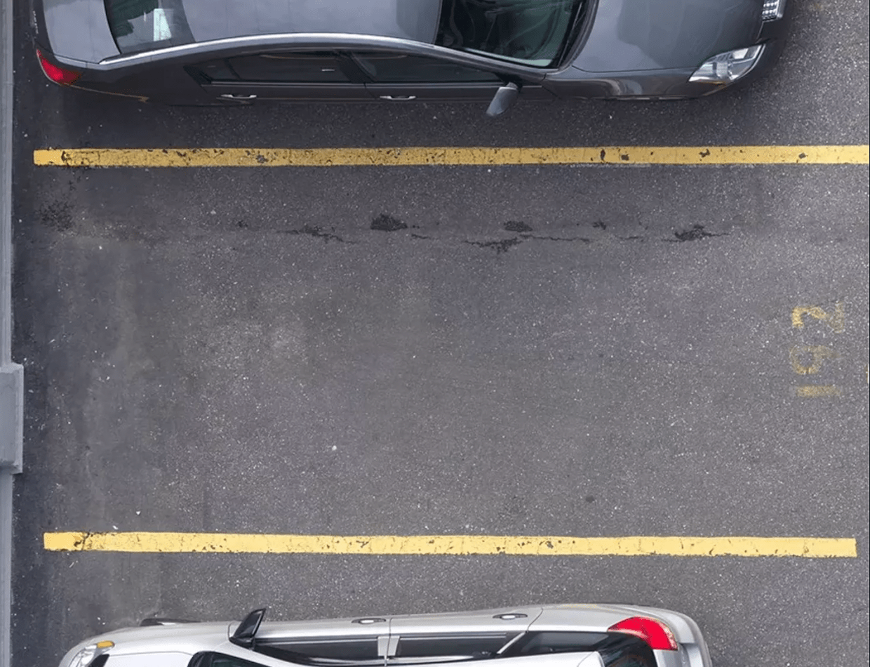 empty parking spot between two parked cars