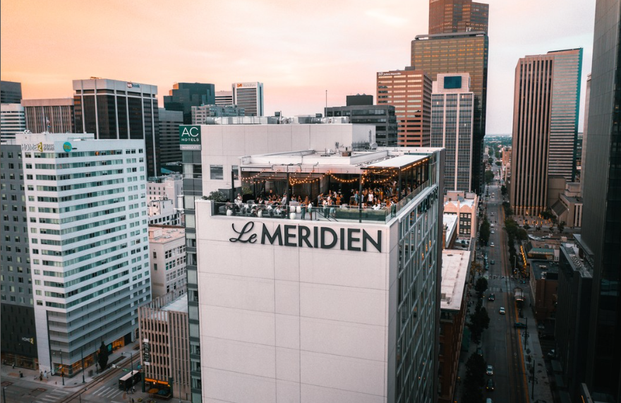 view of a tall building with a rooftop bar