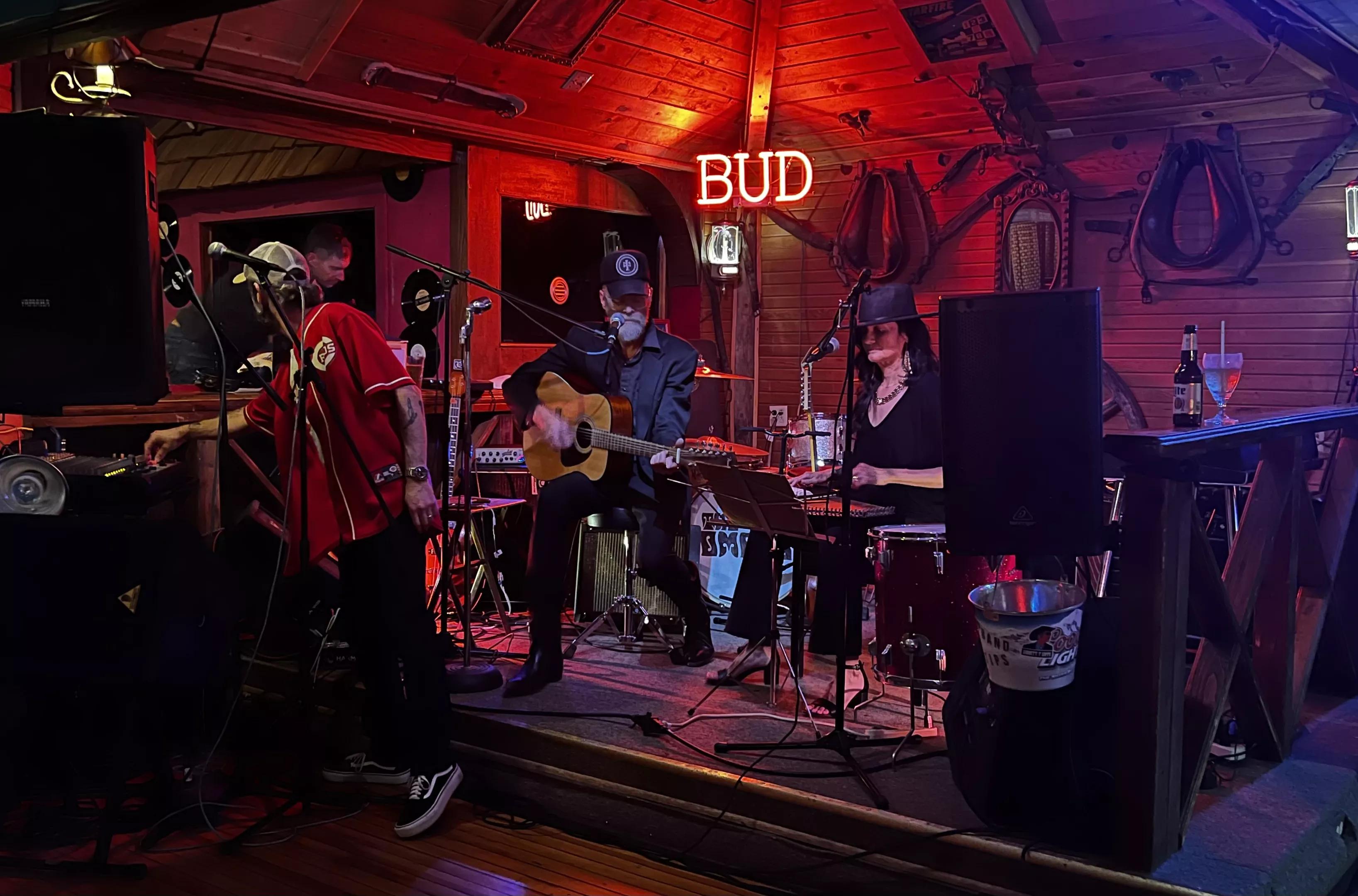 band performing on stage with red and purple lighting