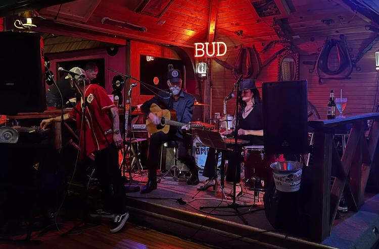 band performing on stage with red and purple lighting