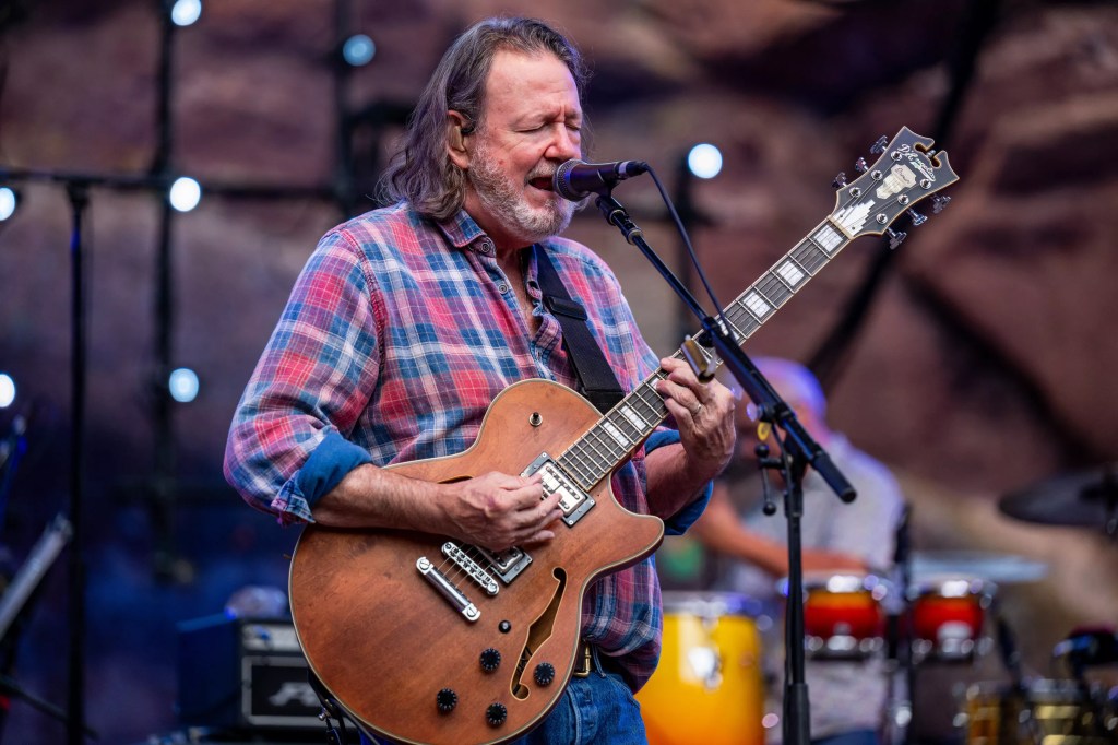 John Bell singing and playing guitar