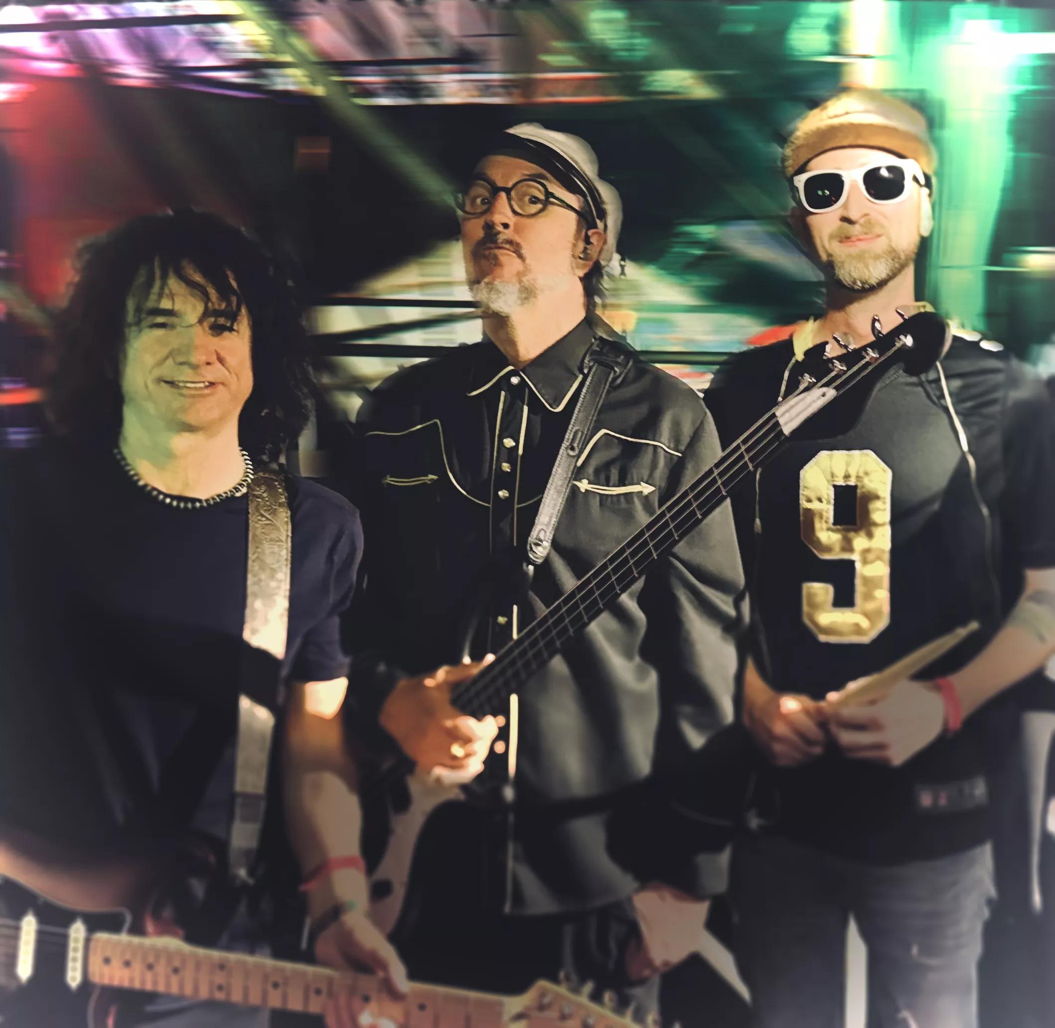 the members of the band Primus pose for a picture