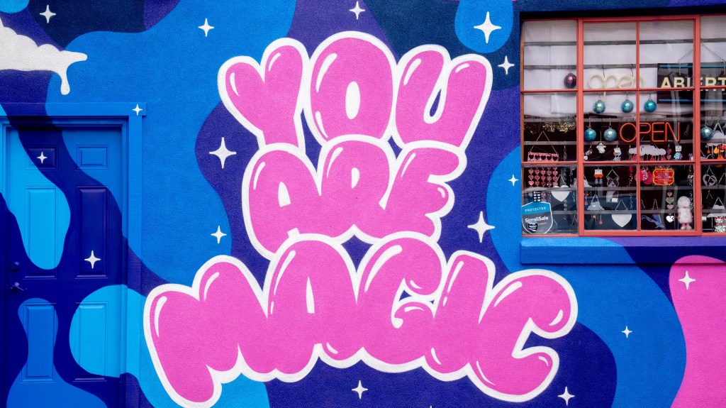 A colorful mural says "You are magic"