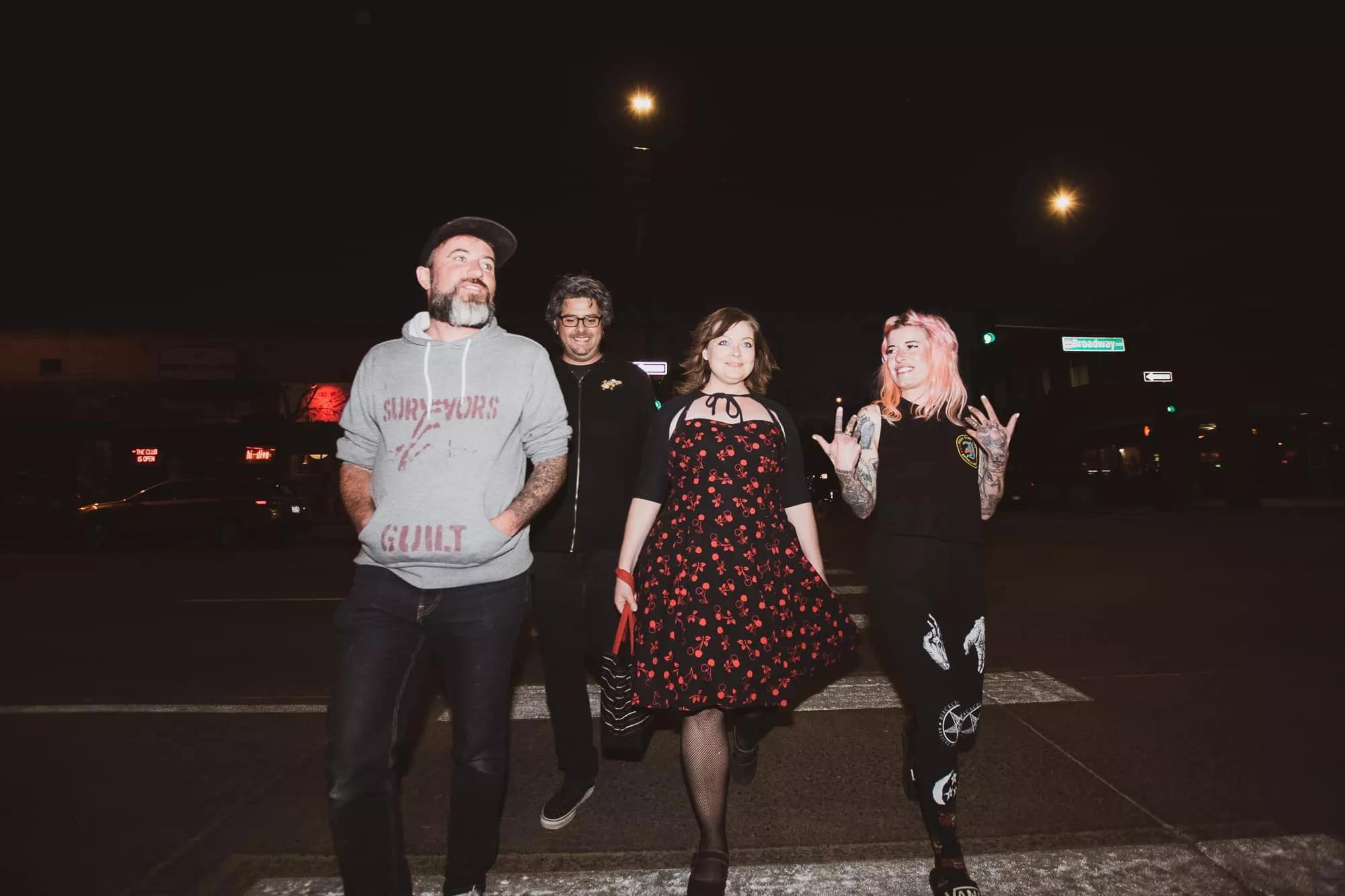 Four people standing in a line