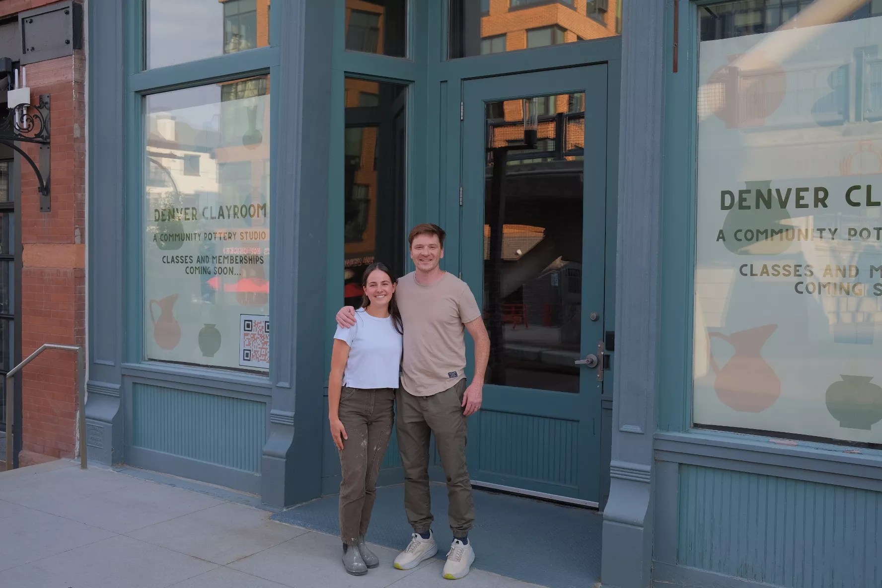 two people stand in front of a building