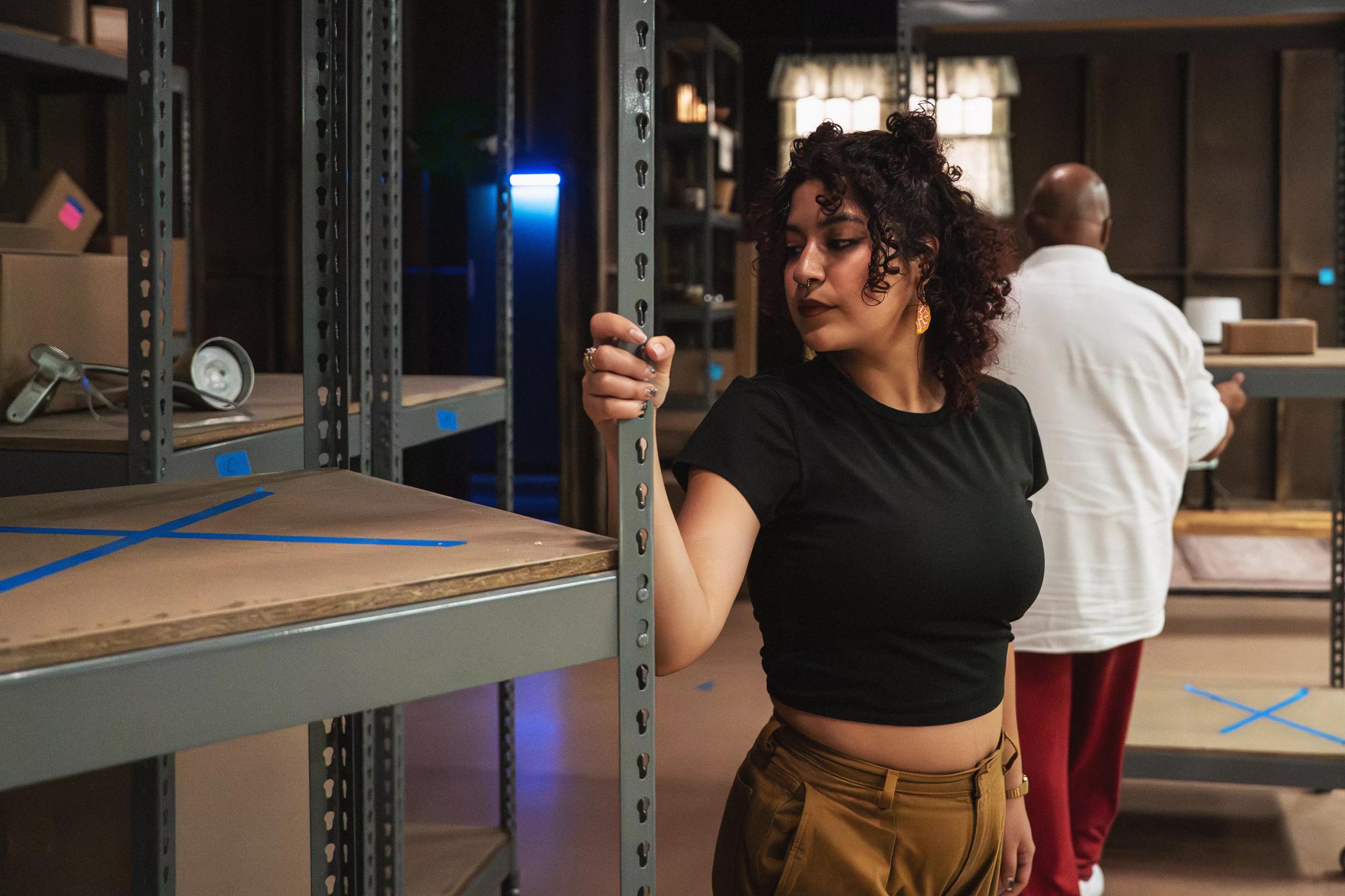 A woman holds the bar of a shelf