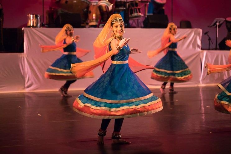 Dancers perform onstage.