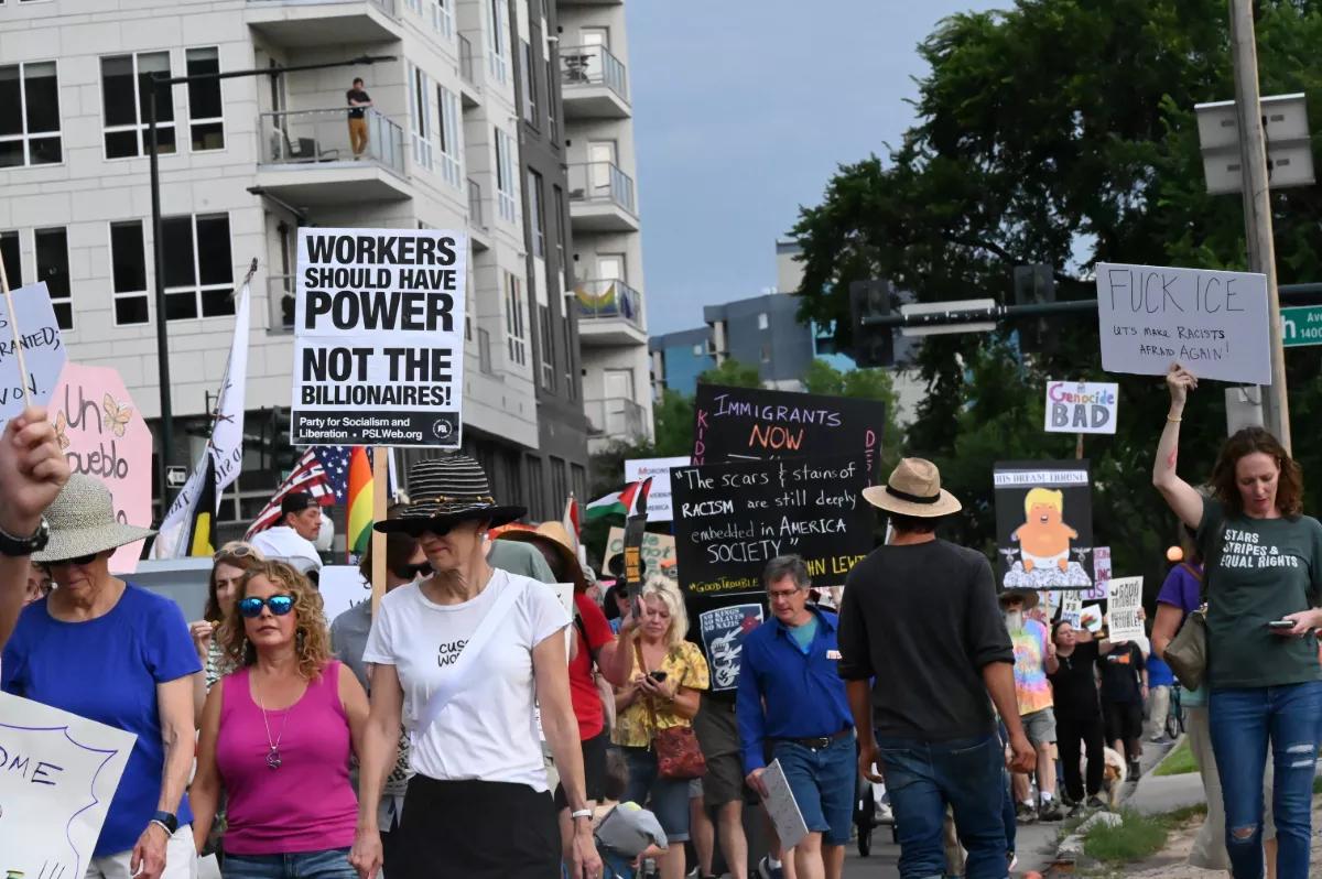 People walk with signs.